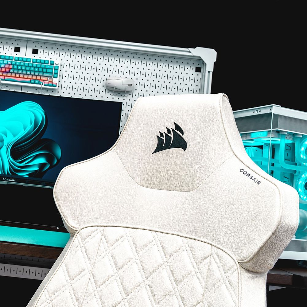 The headrest of a white CORSAIR TC500 LUXE Gaming Chair in front of a CORSAIR Platform:6 desk setup.