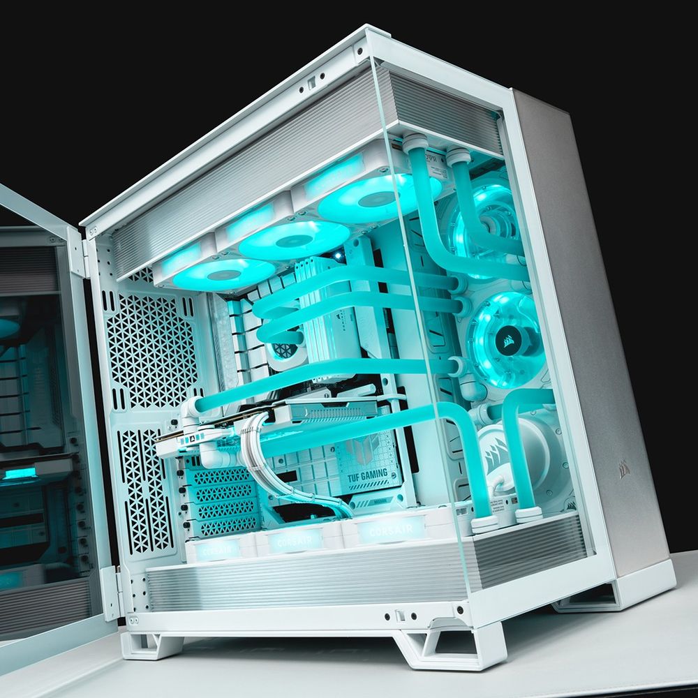 A CORSAIR 6500X with the glass side panel open. The case features the Satin Grey Elite Panels, electric blue coolant, and all white PC internal parts. Parts include the Hydro X iCUE LINK XG7 GPU block, XD7 Pump, XC7 RGB ELITE LCD CPU block, and DOMINATOR TITANIUM RAM.