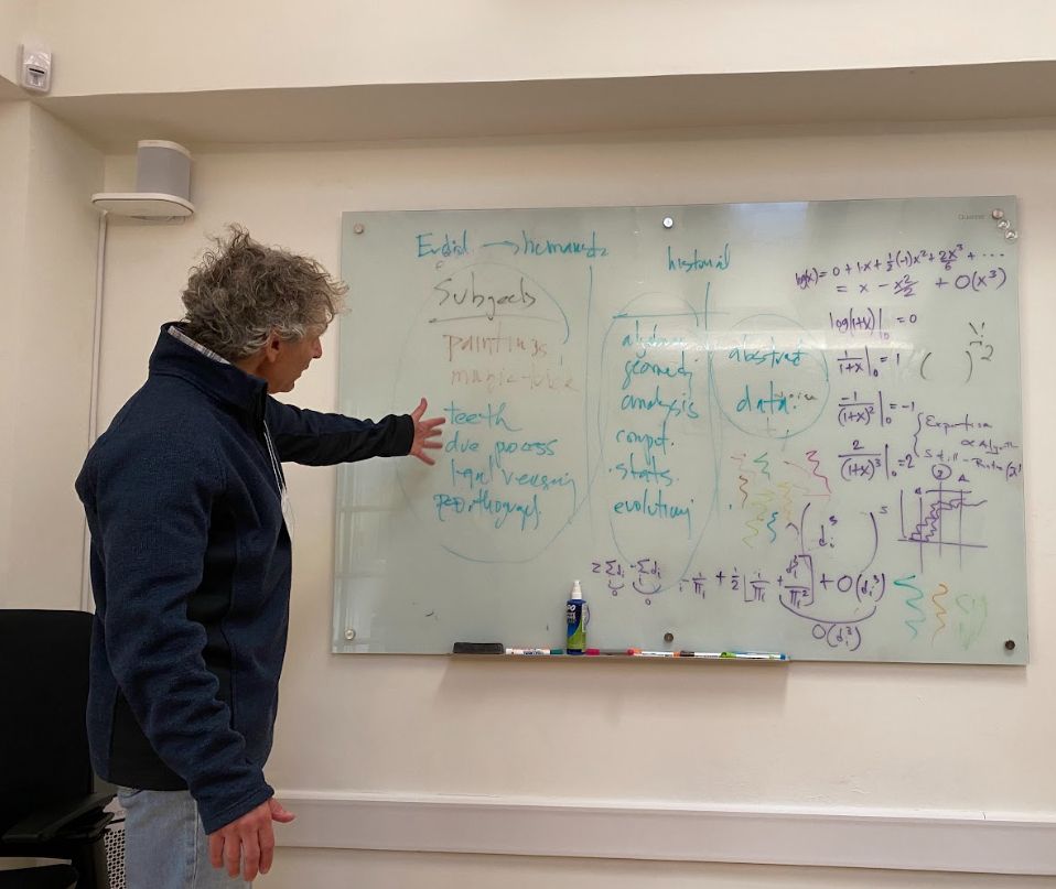 Dan Rockmore, an organizer of the Santa Fe Institute working group on "The New New Science," at a whiteboard in the meeting room of the SFI's Miller campus where the group met. Various humanistic and mathematical ideas are scrawled or listed on the board.