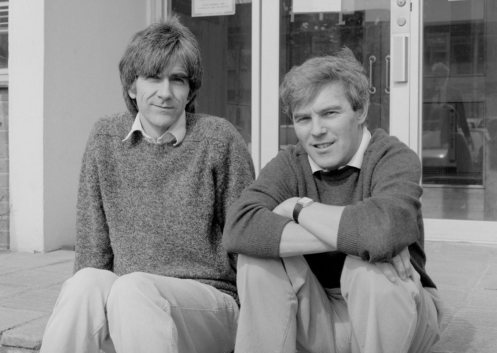 Black and white photograph of Nigel Unwin and Richard Henderson sitting outside the LMB, 1991