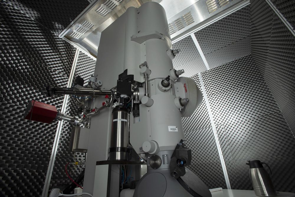 The electron cryo-microscope adapted for use at liquid nitrogen temperatures within its custom-made black box.