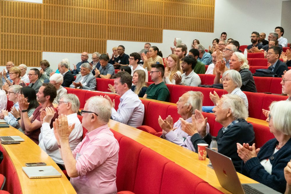 Symposium attendees applauding in the LMB's Max Perutz Lecture Theatre.