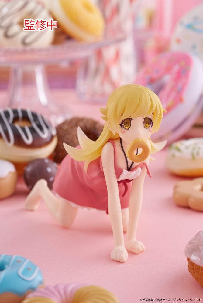 Photo of the Monogatari Series Oshino Shinobu Desktop Cute figure by Taito. She's on all fours with a donut in her mouth. Donuts are all over the background as decoration.