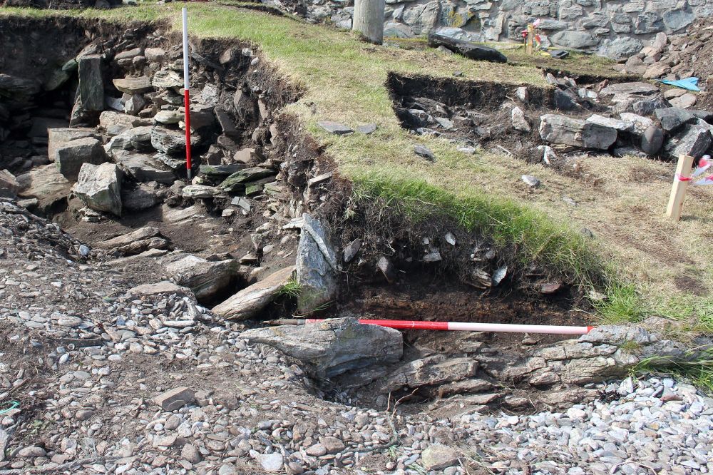Prehistoric buildings exposed by coastal erosion