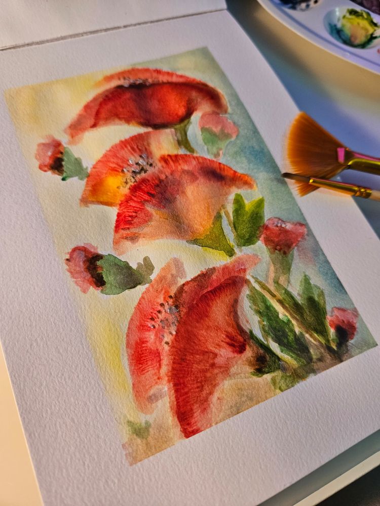 A watercolor painting of red flowers