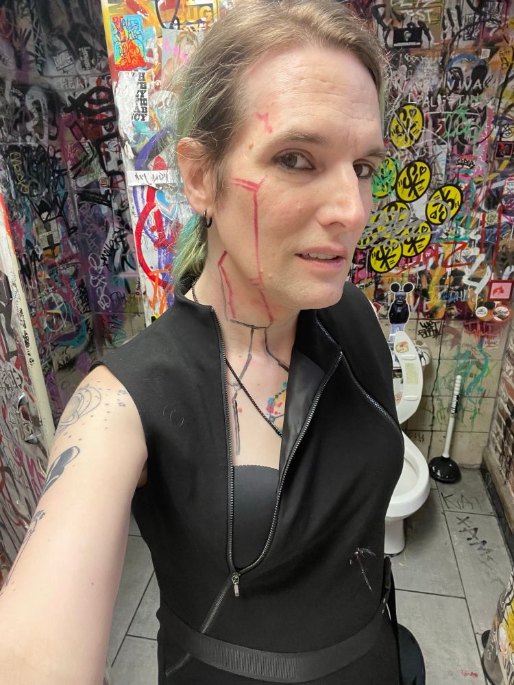 Emi in a black partially unzipped cyberpunk style dress 