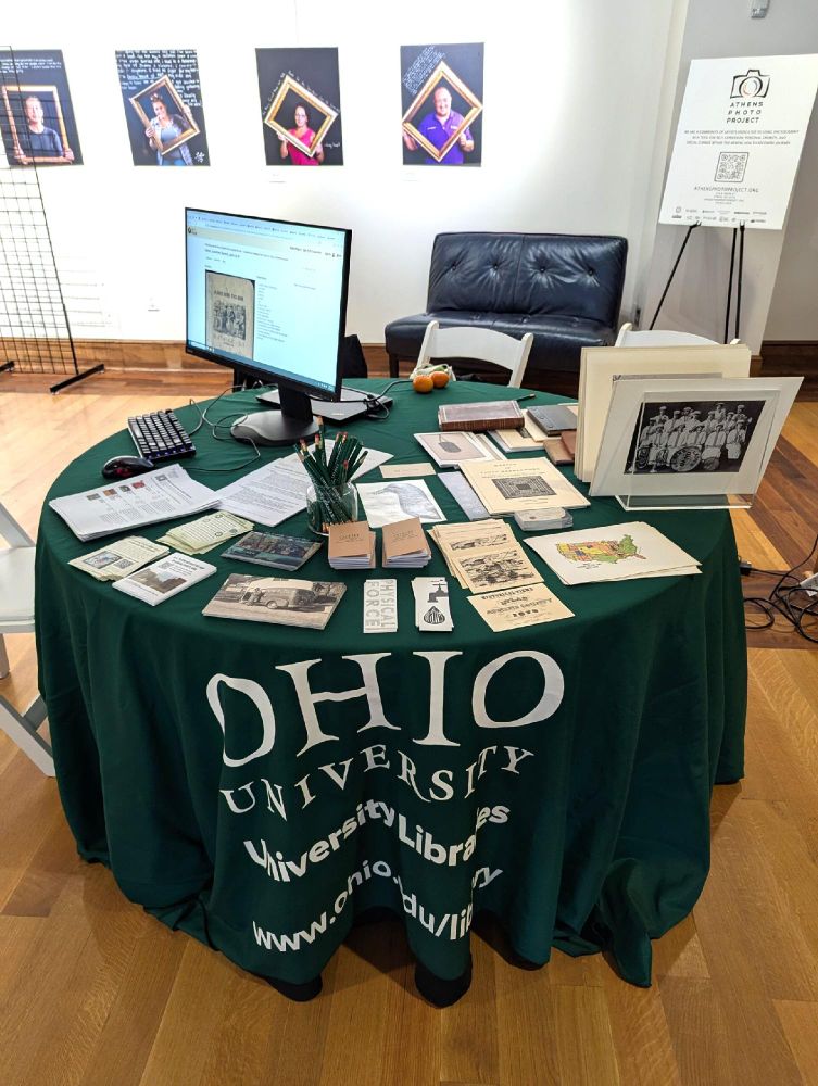Table inside Stuarts Opera House with Ohio University Libraries tablecloth. Various handouts spread on table and some archival materials. September 6, 2025.