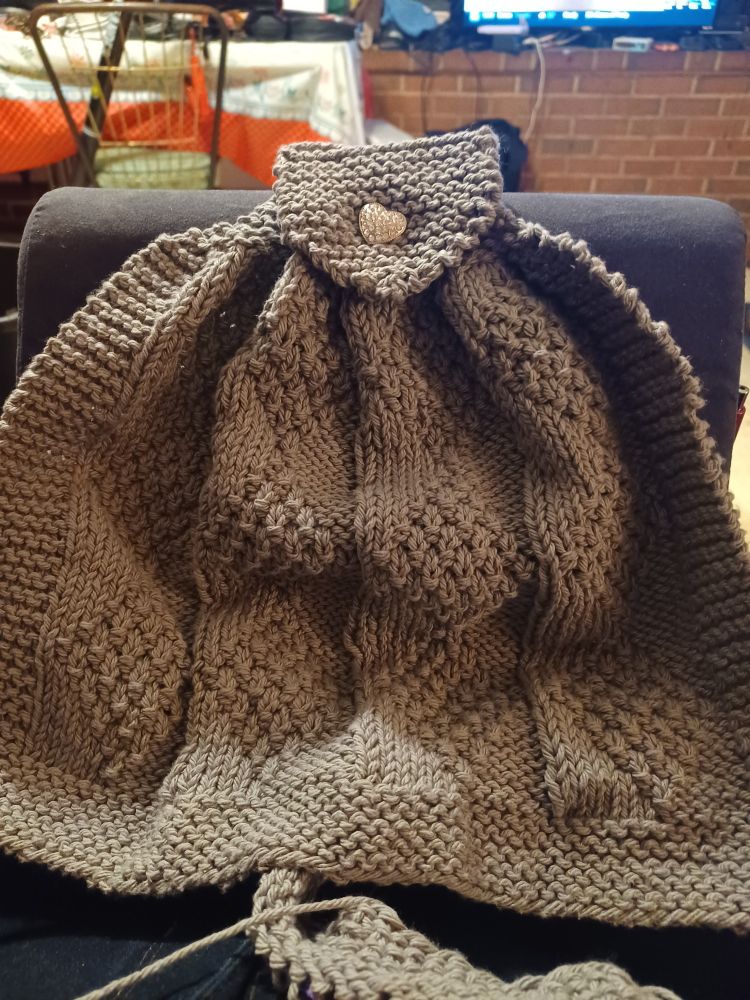 Hanging reverse diamond dishtowel with a shiny heart button.