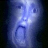 Distorted, blue-tinted screaming man’s face