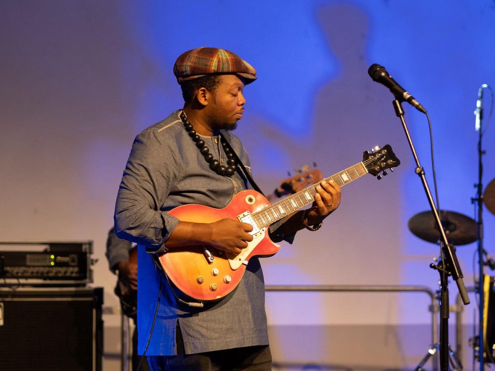 A guitarist performing on stage.