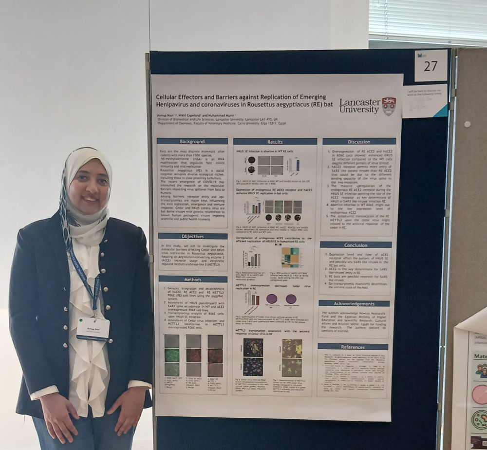 Asmaa standing in front of a poster