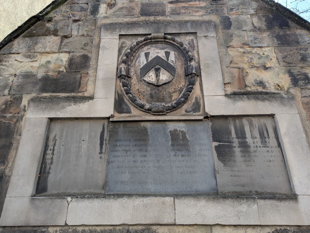 Plague with illegible script and coat of arms
