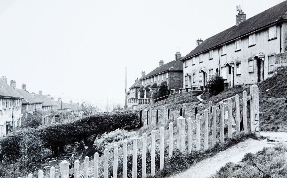 Black and whte image of terraced housing on hill 