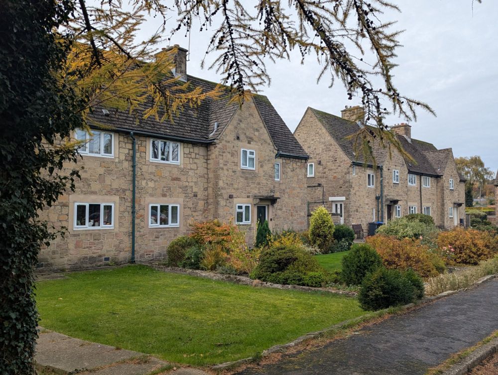 Two-storey council homes in semi-detached terrace in open plan layout.