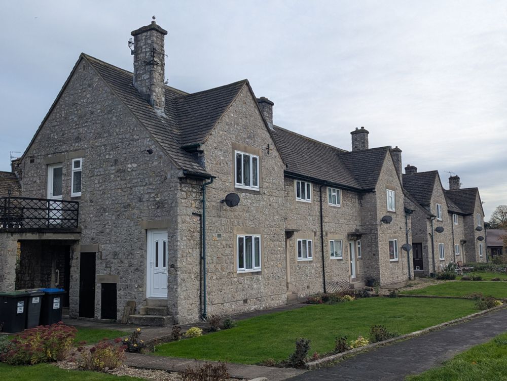 Two-storey council homes in semi-detached terrace showing side entrances