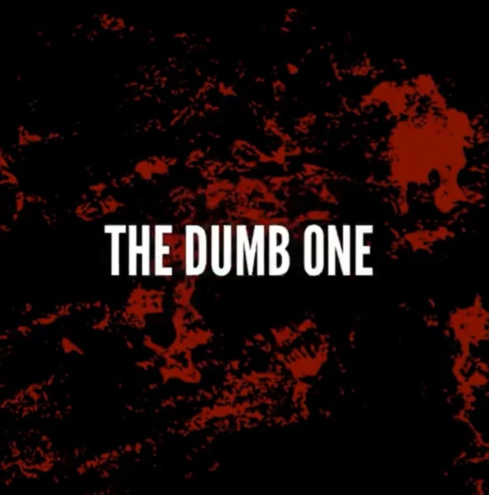 White text on a black and red background 
Text: The Dumb One