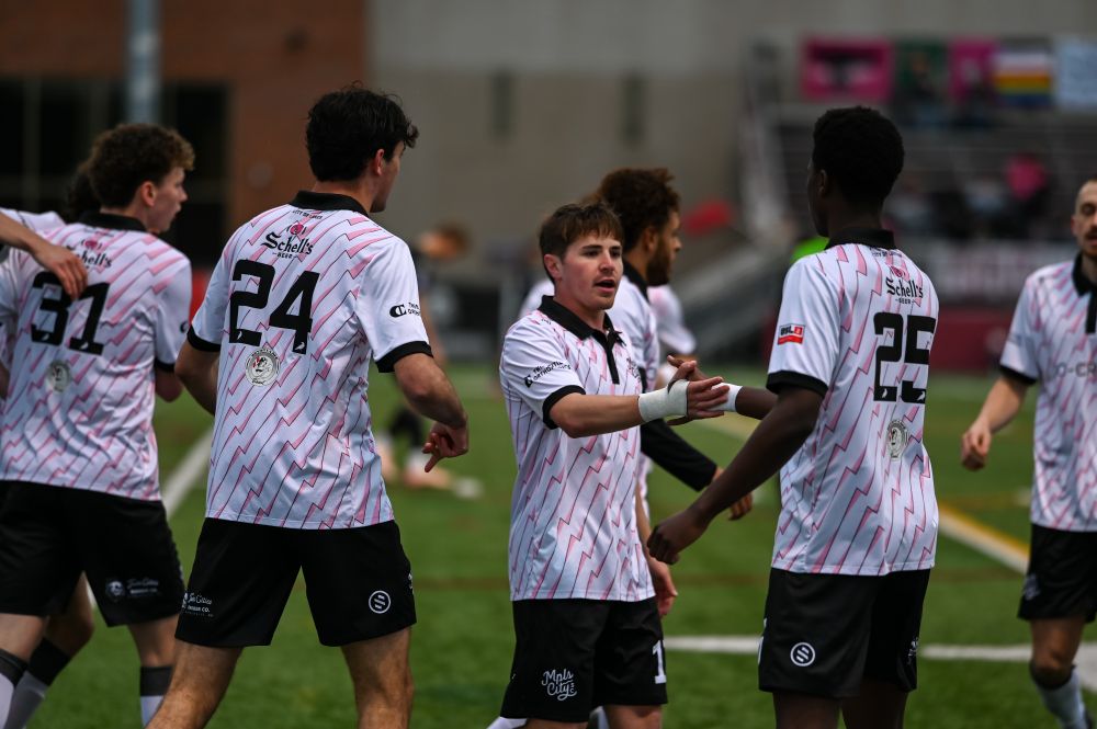 Shea Bechtel celebrating with teammates after a Mpls City Goal