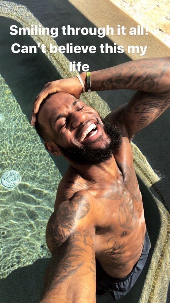 LeBron James looking happy and saying “Smiling through it all! Can’t believe this is my life”