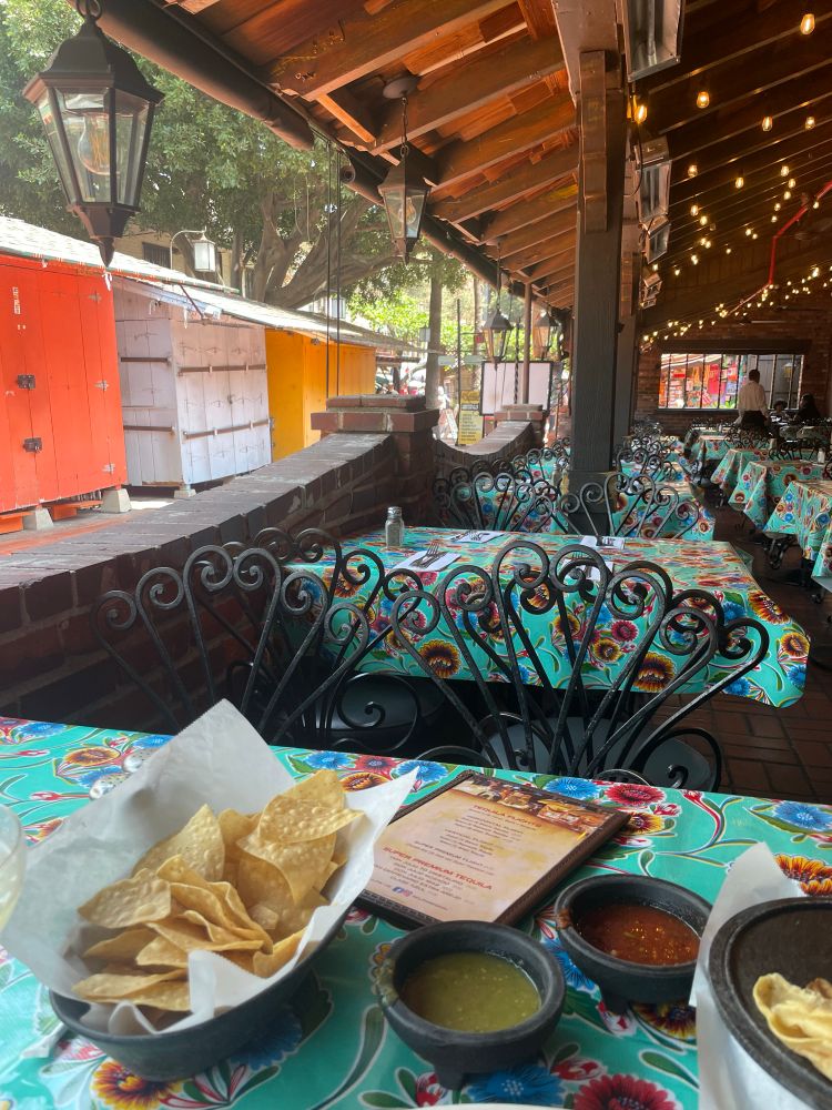 Photo of Olvera Street in Los Angeles in an empty restaurant and locked vendor stalls visible. 