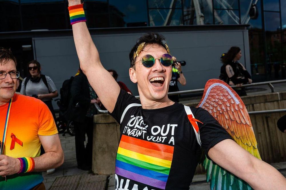 A person with angel wings and rainbow colors celebrates at Liverpool Pride.