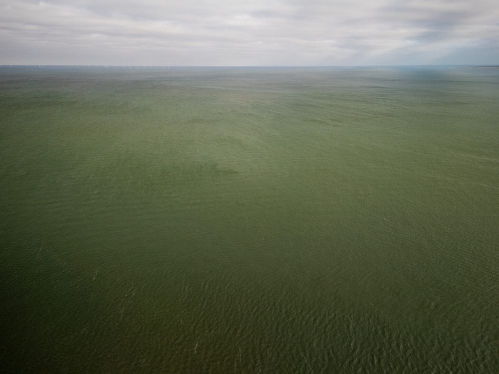 An overcast day over Liverpool Bay, featuring a vast expanse of water and a cloudy sky.