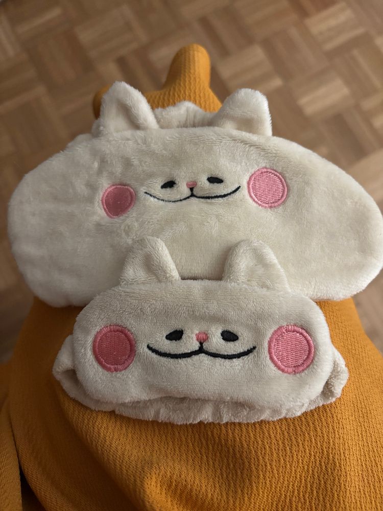 Two sleep eye masks. One of them has been cut and resewn to be a lot smaller