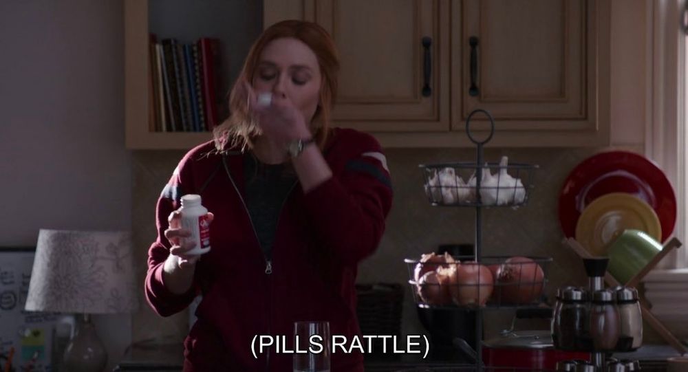 screenshot of Wanda Maximoff from WandaVision taking pills and holding the bottle with the caption "(pills rattle)"