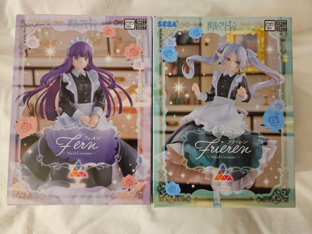 Two figure boxes, one of frieren and one of fern, both in cute maid dresses