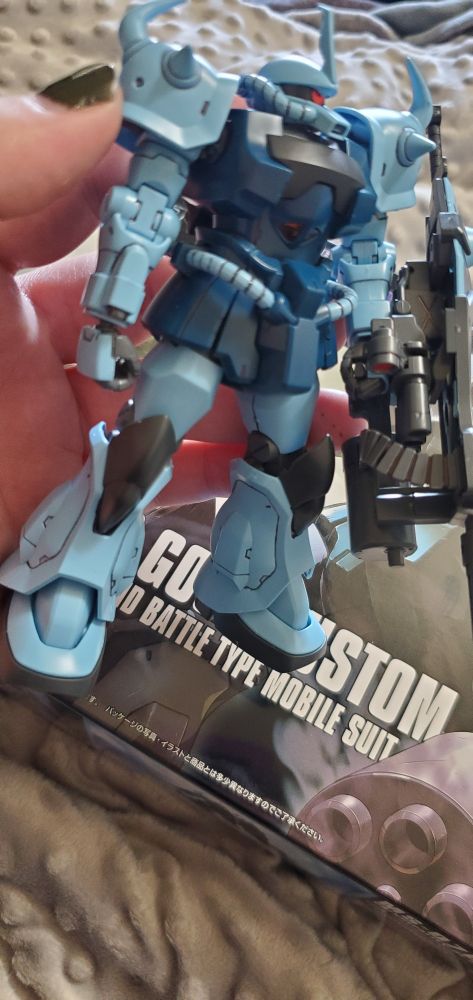 Gouf Custom in Scarlet's hand as she shows it off.