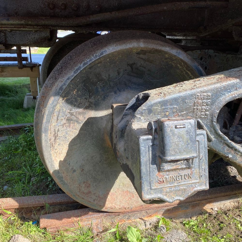 A close up look at the wheel from a caboose.