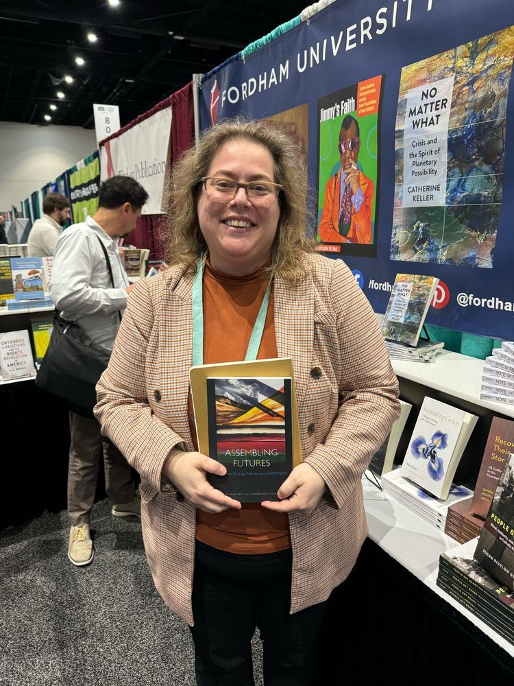 Author with her co-edited volume at the fordham booth