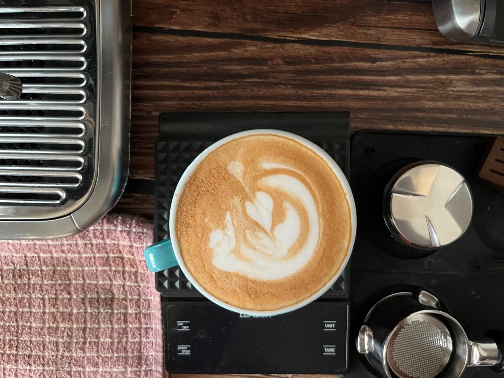 a cup of coffee with a not so perfect latte art.
