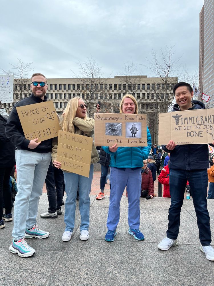 Medical professionals holding protest signs