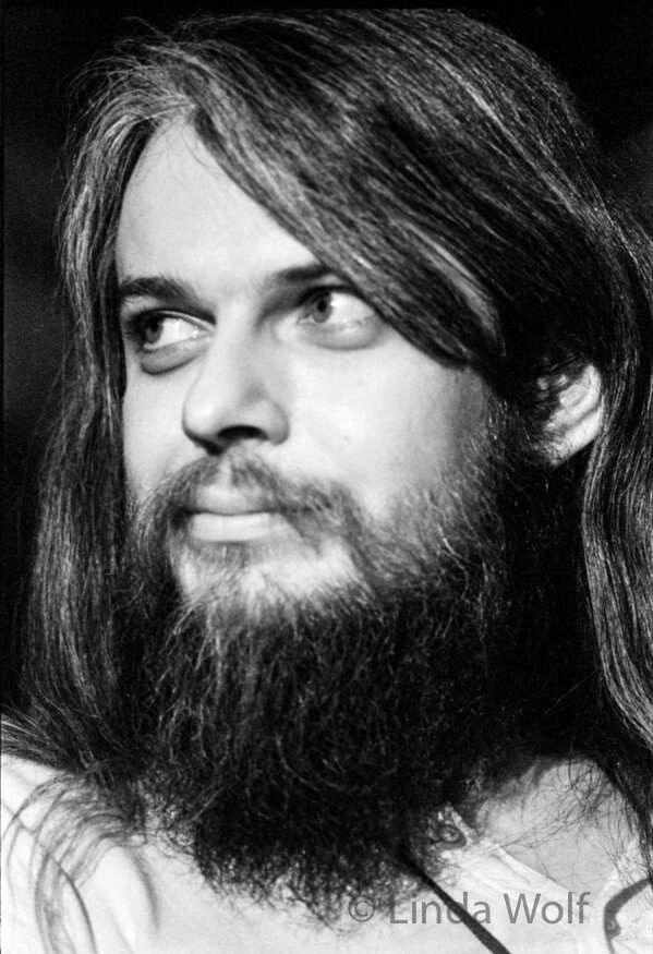 A photo of Leon Russel from the 70's sporting a bad beard and mustache with long hair.