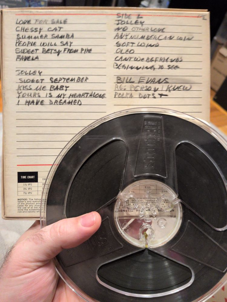 It's an old 1/4" reel with the Backcover of the box for it. The backcover has a list of songs like I have dreames, jolley, summer samba and bill evans is named. They're all aongs recorded off the radio 