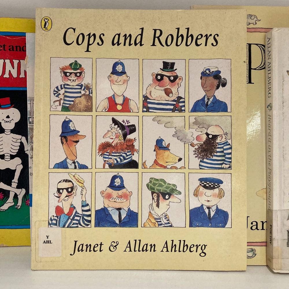 The front cover of Cops and Robbers by Janet and Allan Ahlberg on a library shelf.
