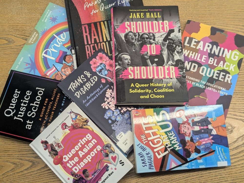 Colourful books from the display are arranged face-up on a table.