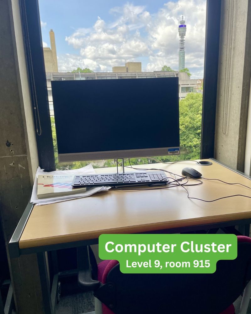 Computer on desk by a window with a view of the BT tower. Text says Computer Cluster, level 9, room 914.