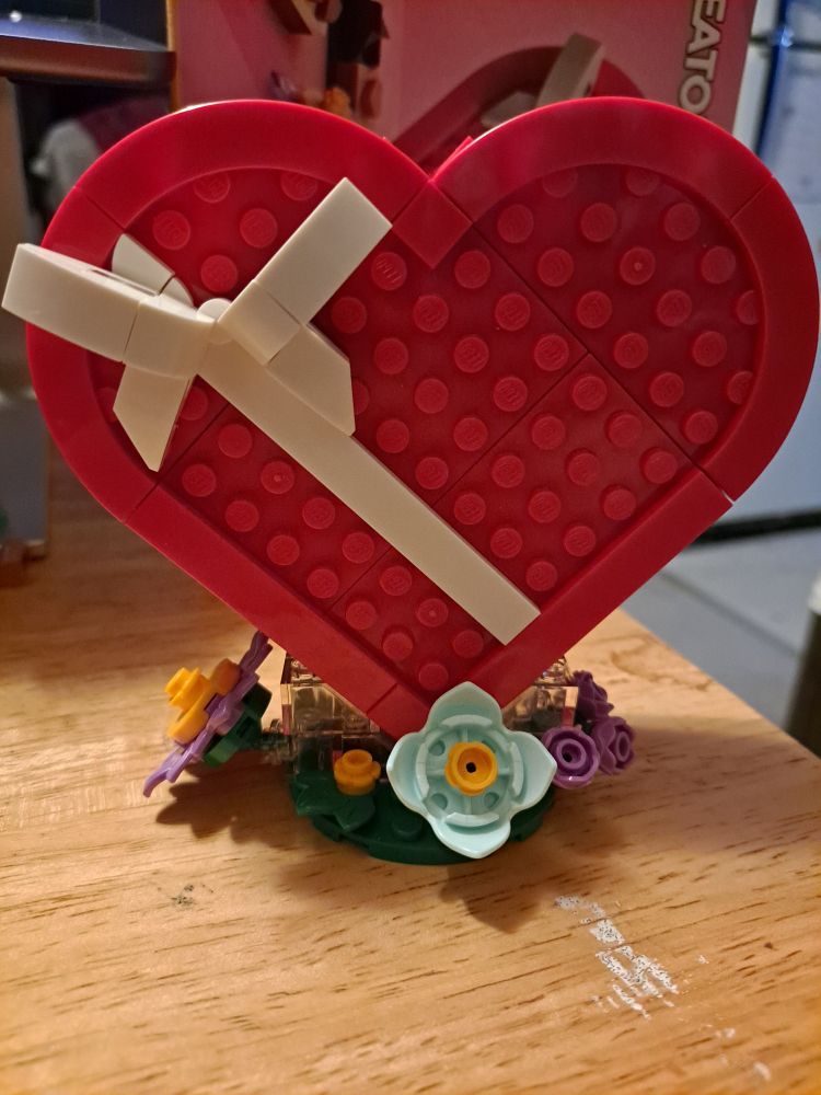 the Lego heart box completely assembled and placed upon its little Lego flower base.