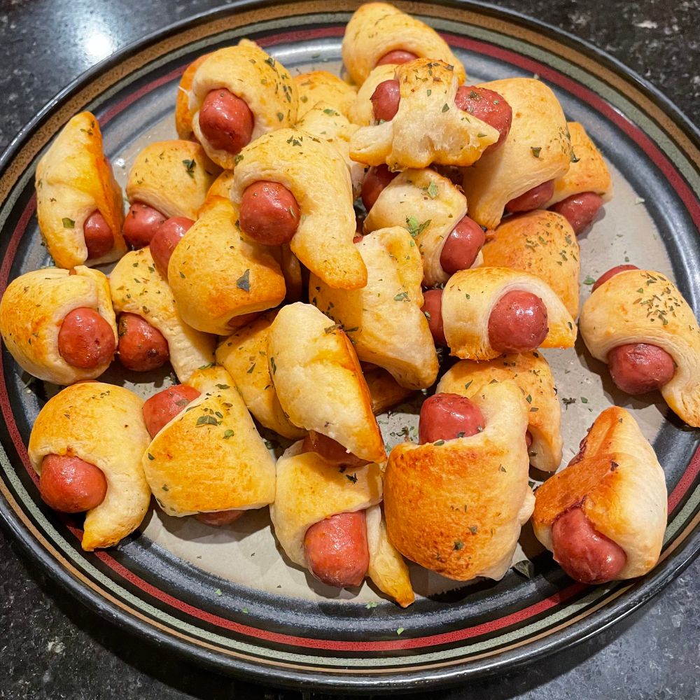 Pigs in a blanket, brushed with buffalo wing sauce and topped with thyme and oregano from the garden