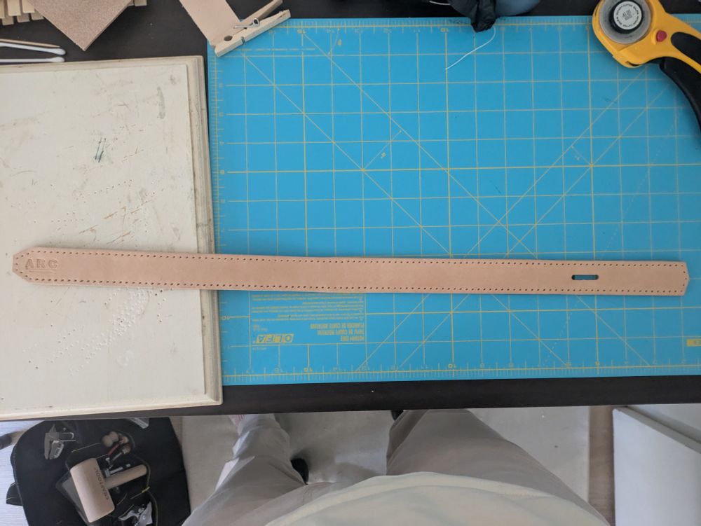 Stitch holes punched in the leather strap.