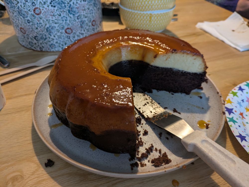 Chocoflan, a chocolate cake base with a top half made of creamy flan, with a slice removed