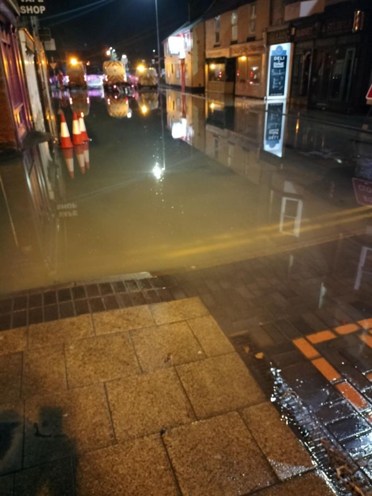 Burst pipe flooded across high street. 