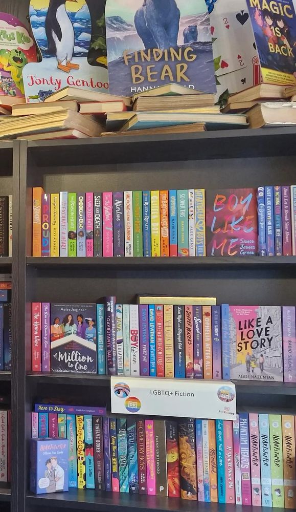 Photo of LGBTQ+ YA shelves in Wonderland Bookshop 