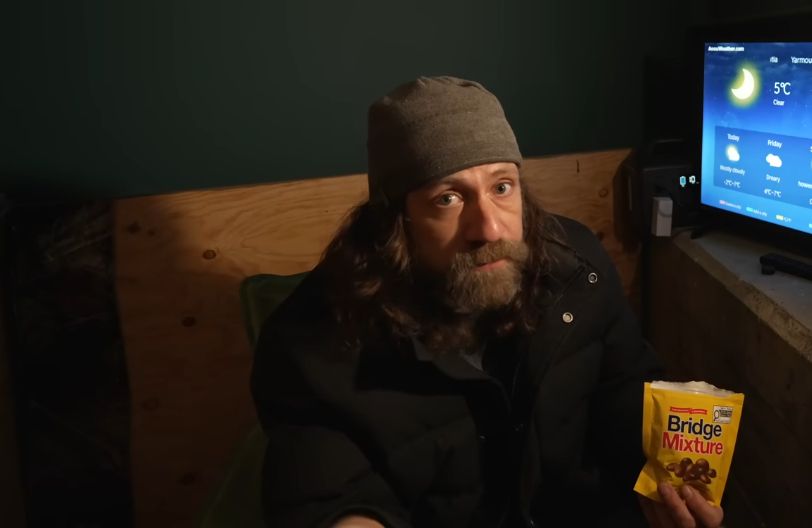 steve the camping guy from youtube eating bridge mixture while camping under a bridge