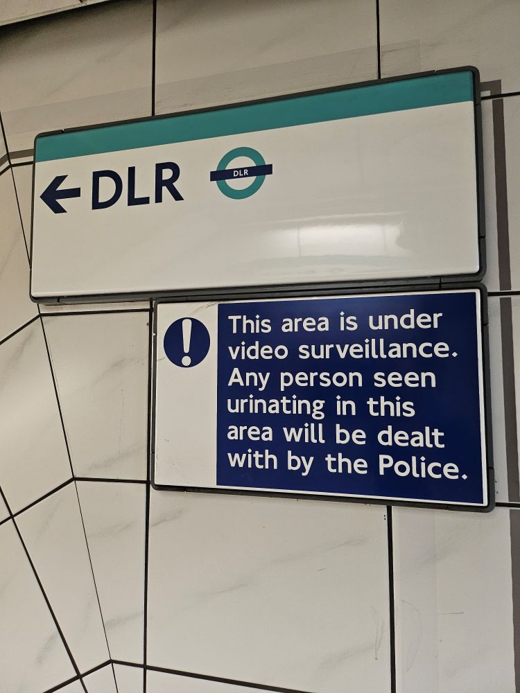 A sign promising to prosecute anybody urinating on the stairs. Just think what it would've taken for them to put up a sign.