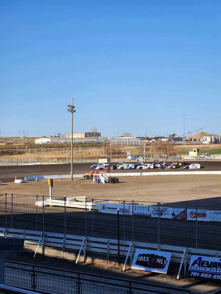 bunch of cars on a dirt track