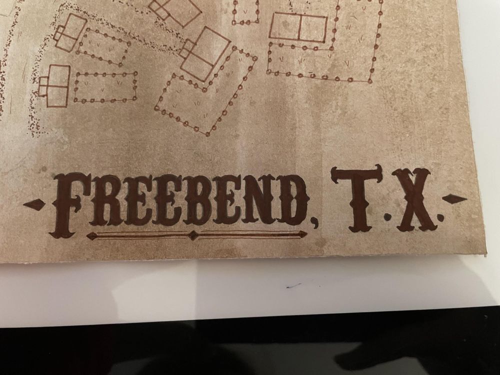 An old time map of a fictional town called Freebend, Texas. The title invokes a western feel with a serif font and some 1800's elements and filigree.