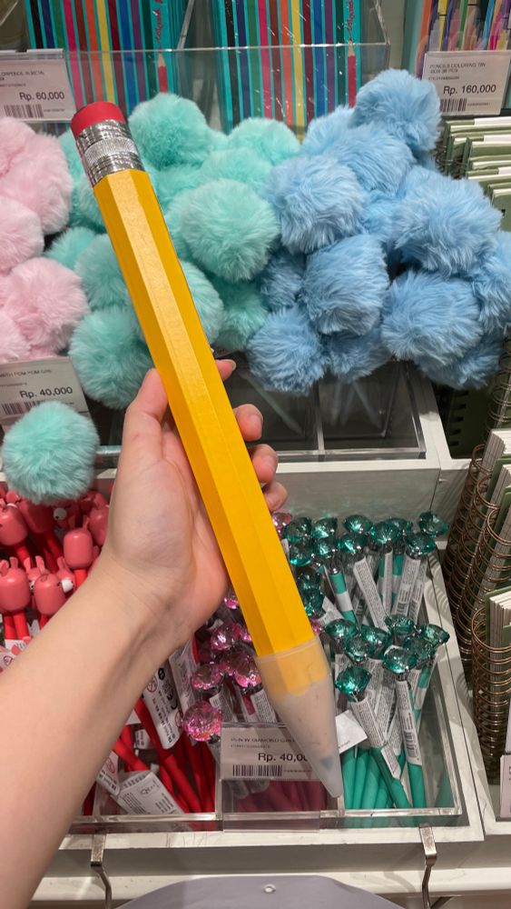 a gigantic yellow pencil, reminiscent of the one from spongebob squarepants “Frankendoodle” episode