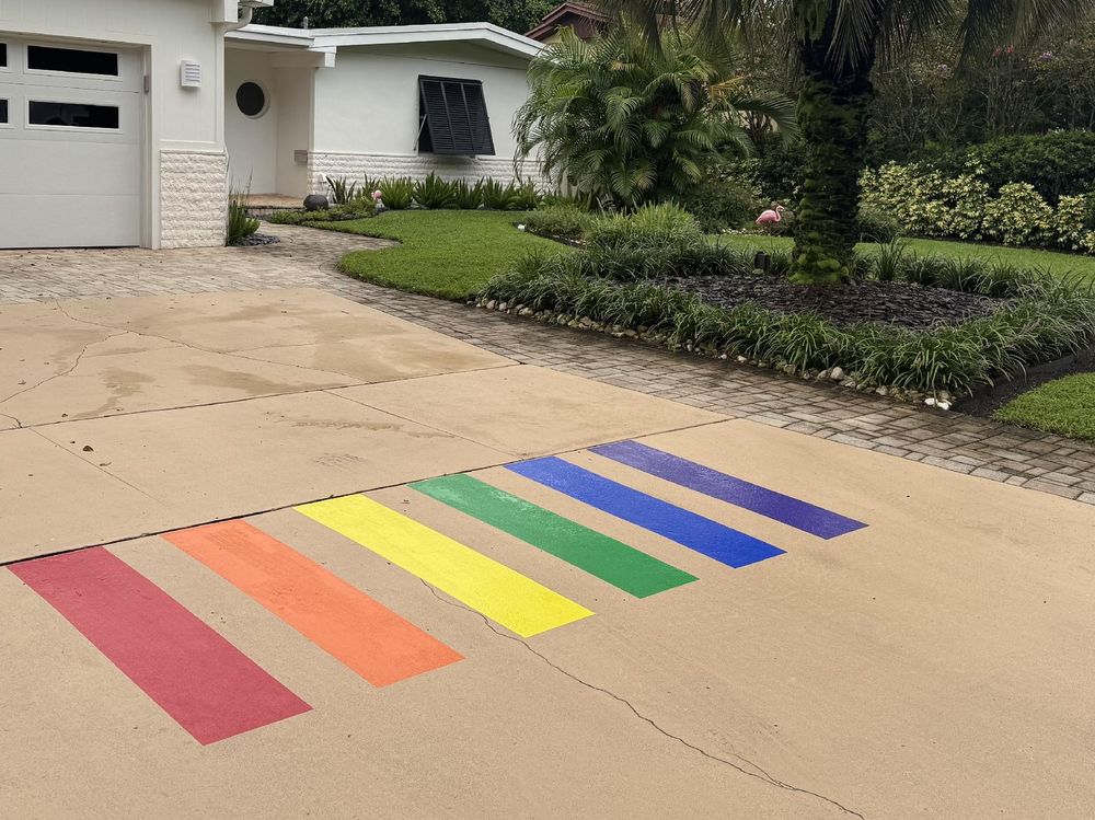 A residential driveway in Orlando with rainbow stripes painted on it to match the Pulse memorial crosswalk.